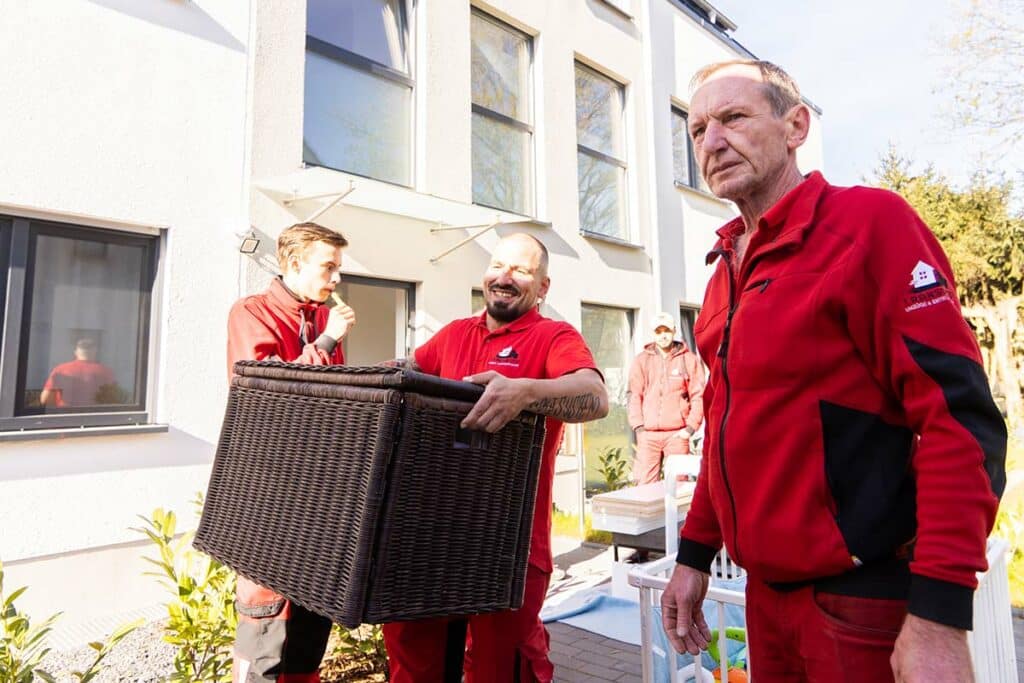 Fröhliche Mitarbeiter von TransMoto bei einer Entrümpelung